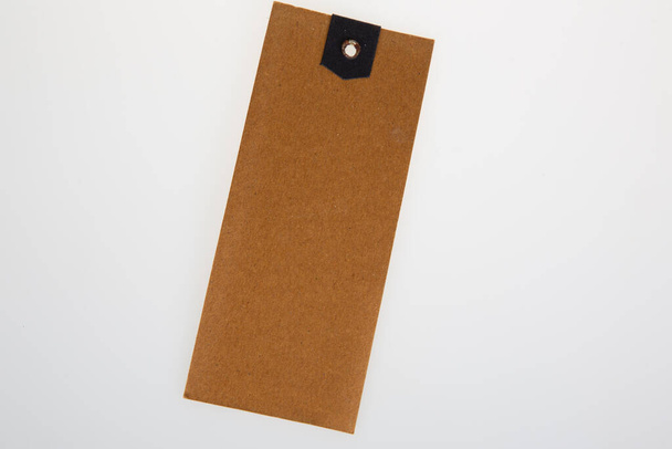 Blank kraft paper badge label brown carton of clothing isolated on white empty background - Photo, Image