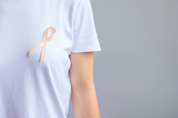 Peach Ribbon for September Uterine Cancer Awareness month. Healthcare and World cancer day concept - Fotografie, Obrázek