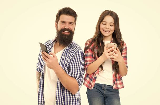 Parental monitoring app. Interfering too much with privacy. Privacy concept. Privacy online. Man father and little girl daughter with smartphones. Leading with trust. Let teen have some phone freedom - Photo, Image
