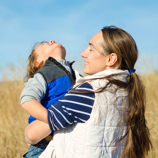 mother and child in the field outdoors - Photo, Image