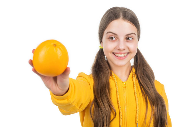 happy teen girl with orange citrus fruit. vitamin and dieting. child eating healthy food. - Fotó, kép
