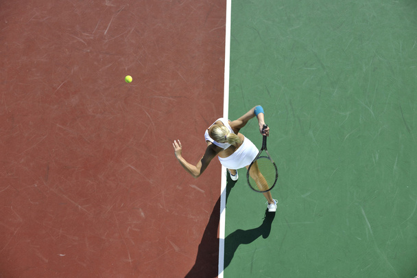 Young woman play tennis outdoor - Фото, зображення