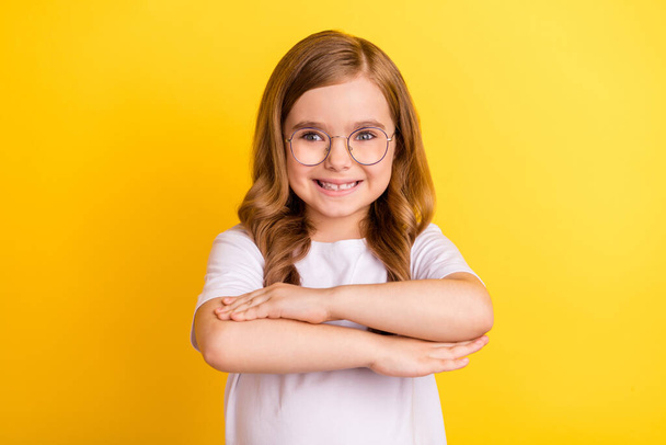 Photo of young school girl happy positive smile hands pupil clever lesson isolated over yellow color background - Zdjęcie, obraz