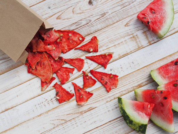 Healthy food from natural products. Homemade sweet healthy dessert made from dried watermelons for children and adults in a paper bag. - Photo, Image