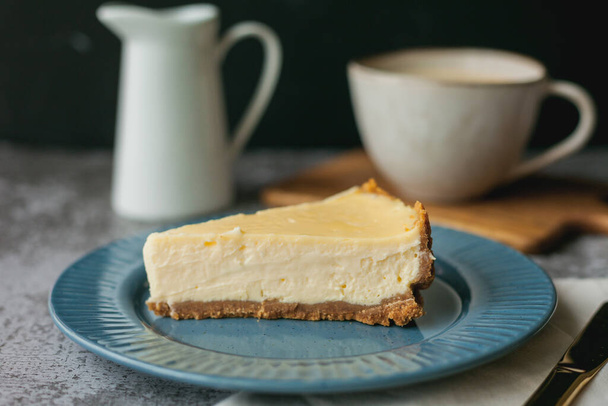 Bakery products. A piece of homemade cheesecake and a mug of coffee. - Photo, Image