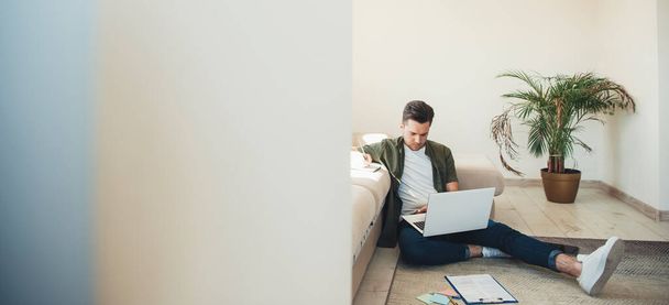 Businessman at home working at laptop on floor. Online career. Internet technology. Sitting man. Computer technology. Business technology. - Photo, Image