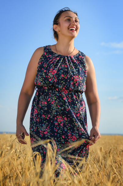Ridendo abbronzata donna vivace in un campo di grano
 - Foto, immagini