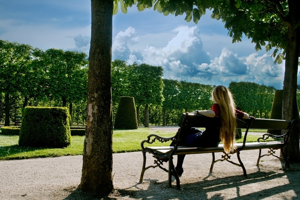 Back of young woman relaxing in park - Photo, image