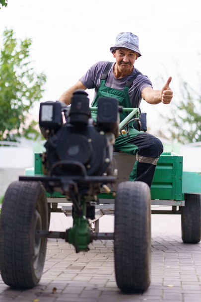 Мужчина-фермер с трактором за спиной - Фото, изображение
