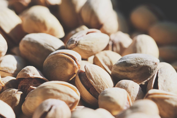 Organic pistachios in the sun, healthy food and snack background - Photo, Image