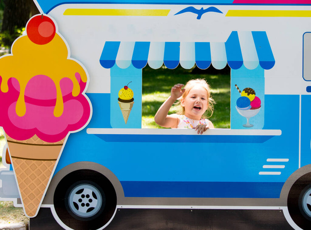 Το παιδί προσποιείται ότι πουλάει παγωτό από ένα παγωτατζίδικο. - Φωτογραφία, εικόνα