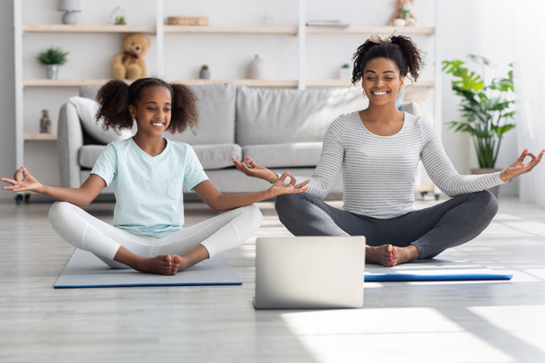 Cheerful black mom and daughter having online yoga class - Photo, Image