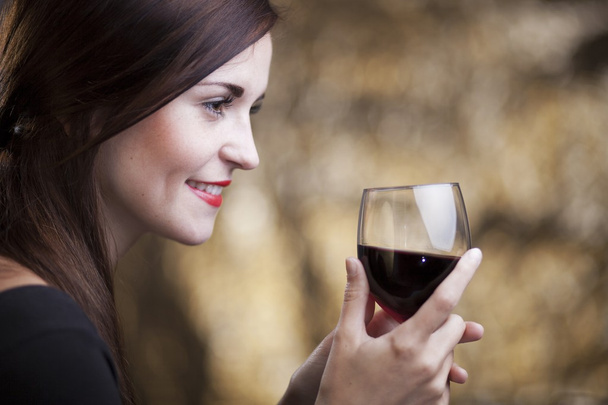 Elegant glamour woman with glass of red wine - Фото, зображення