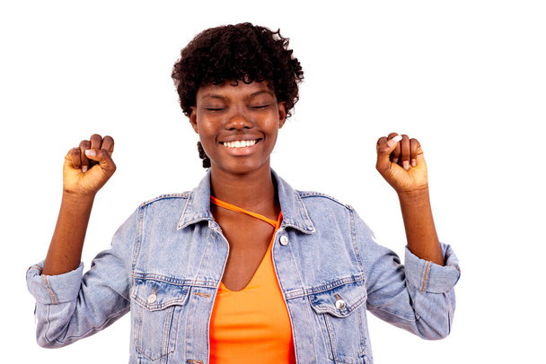 young student in jacket standing on white background making winner gesture with closed ones smiling. - Fotó, kép