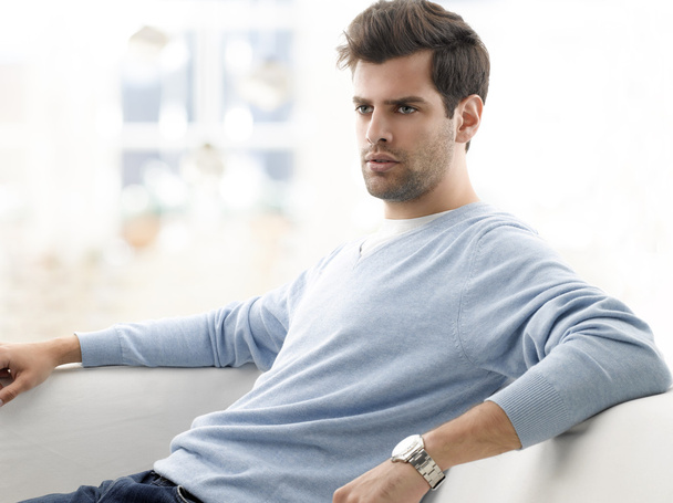 Modern young man relaxing on sofa - Photo, image