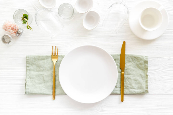 Tableware set with empty plate with dishware and glasses on napkin - Foto, Imagen