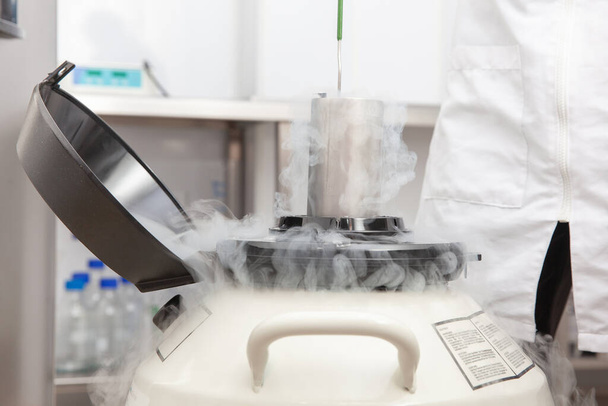 Kühltank für flüssigen Stickstoff im Life-Sciences-Labor: Stickstoffdampf aus flüssigem Stickstoff, der Umgebungstemperaturen ausgesetzt ist - Foto, Bild