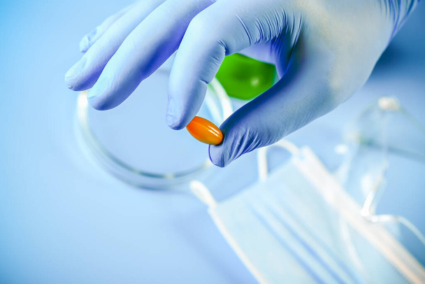 doctor's hand in a glove holds omega 3 vitamins. Fish oil. Medical concept. - Photo, image