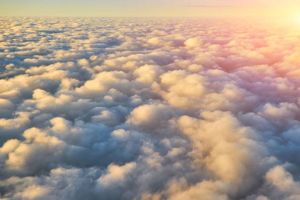 Spectacular view of a sunset above the clouds from airplane window - Photo, Image
