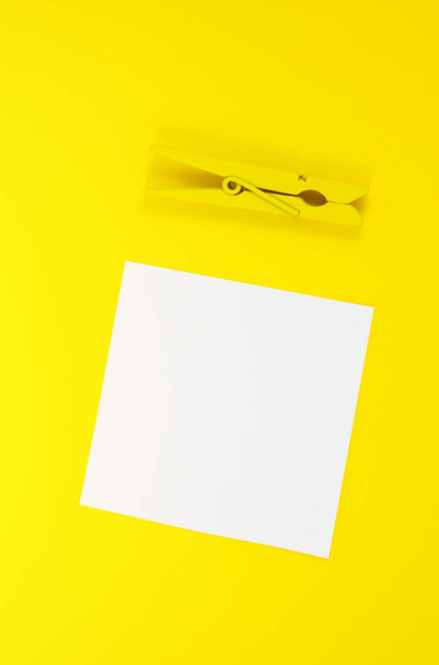 Blank white To Do List Sticker with yellow wooden clothespin. Close up of reminder note paper on the yellow background. Copy space. Minimalism, original and creative photo. - Zdjęcie, obraz