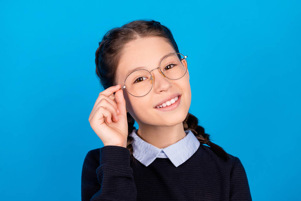 Portrait of young cheerful beautiful lovely intelligent schoolgirl wear spectacles isolated on blue color background - Zdjęcie, obraz