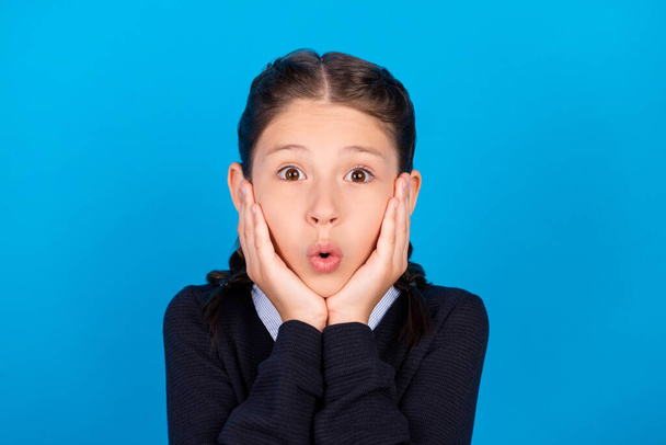 Photo of shocked amazed crazy schoolgirl touch cheekbones big sale discount black friday isolated on blue color background - Zdjęcie, obraz