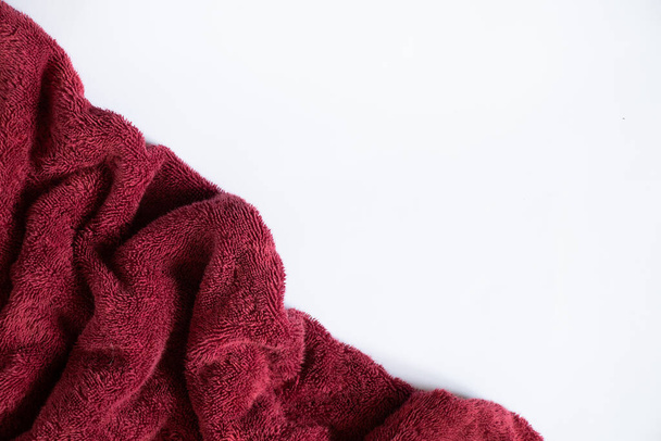 red towel folded lies on a white background, bath red towel on an isolated background - Photo, Image