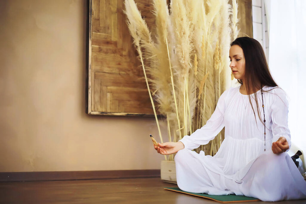 Piękna sportowiec dziewczyna robi ćwiczenia jogi cieszyć się medytacją w domu. Brak stresu, zdrowy nawyk, koncepcja odprężenia. Lotos. - Zdjęcie, obraz