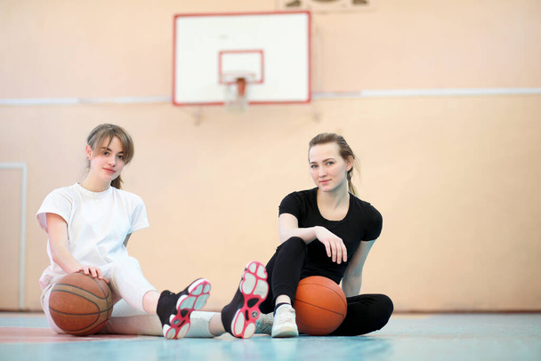 Dívka mladý student v tělocvičně hrát basketbal - Fotografie, Obrázek