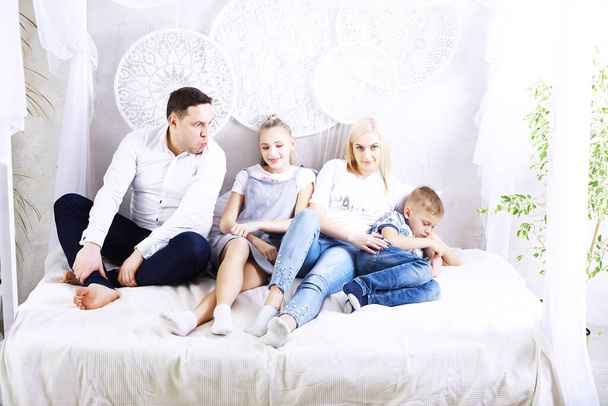 Funny active family of young adult parents and cute small children playing together in living room interior, carefree little kids with mum dad having fun laughing enjoy leisure at home - Photo, Image
