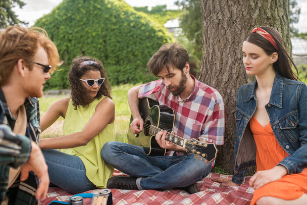 Romantic young people with guitar in nature - Photo, Image