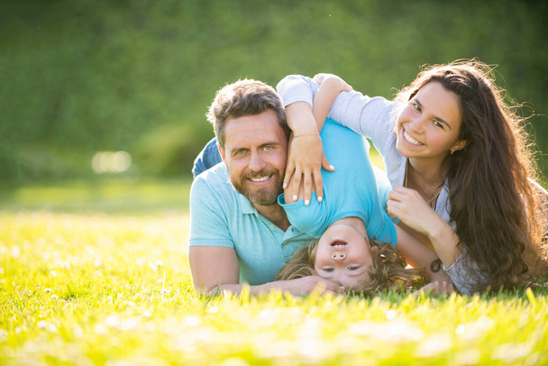 happy family of mom father and son child relax in summer park green grass, family - Photo, Image
