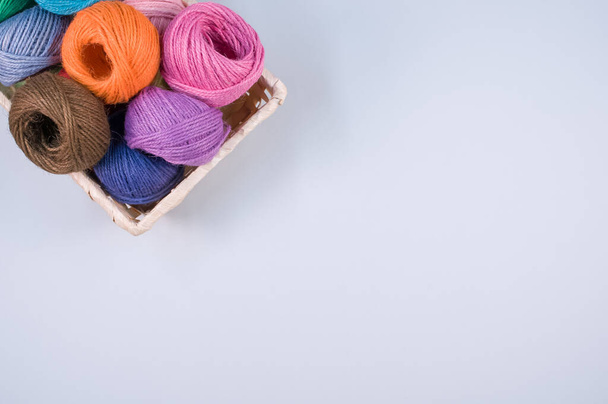 A basket full of colorful yarn rolls isolated on a white background with free space for text - Photo, Image