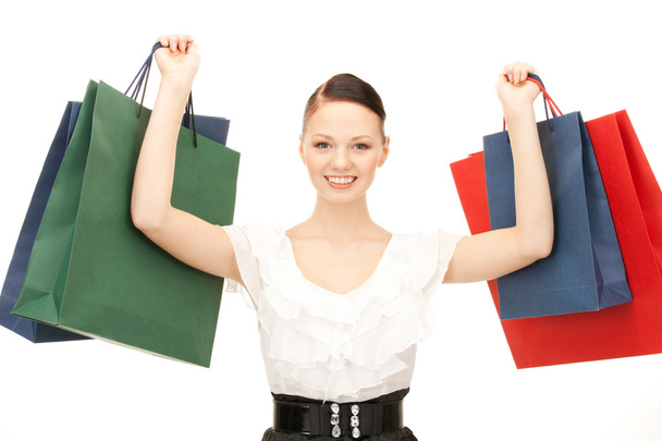 Lovely woman with shopping bags over white - Foto, imagen