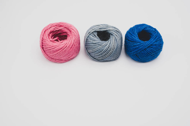 A closeup shot of colored cotton threads on a white background - Photo, image