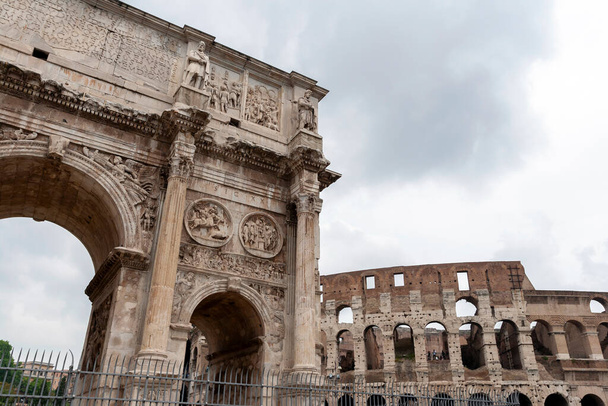 Arch of Constantine on a cloudy summer day in Rome. The Arco di Costantino is a triumphal arch in Rome dedicated to the emperor Constantine the Great, it was built in AD 315. - Photo, Image