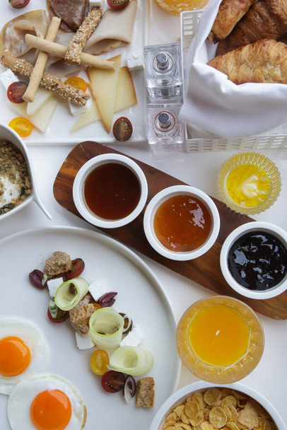 Breakfast in luxutry hotel with orange juice and various delicious choices of food. - Photo, Image