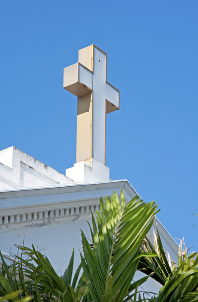 Cross on the roof top of an old white church - Photo, Image