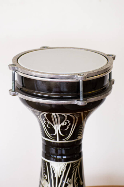 A vertical shot of a bongo instrument on a white background - Photo, Image