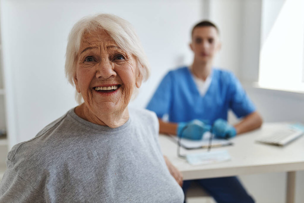 anciana alegre en el hospital que recibe una consulta de comunicación con el médico - Foto, Imagen