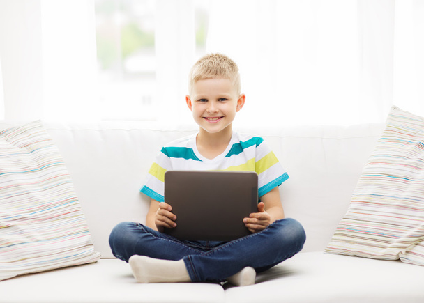 smiling boy with tablet computer at home - Foto, Bild