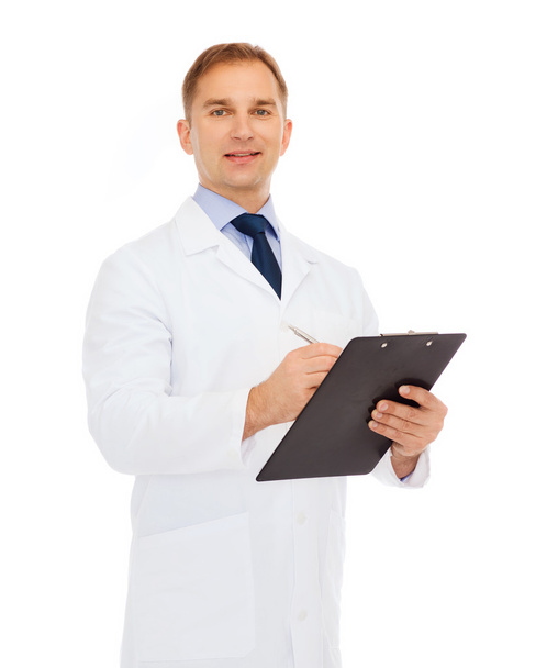smiling male doctor with clipboard - Fotó, kép