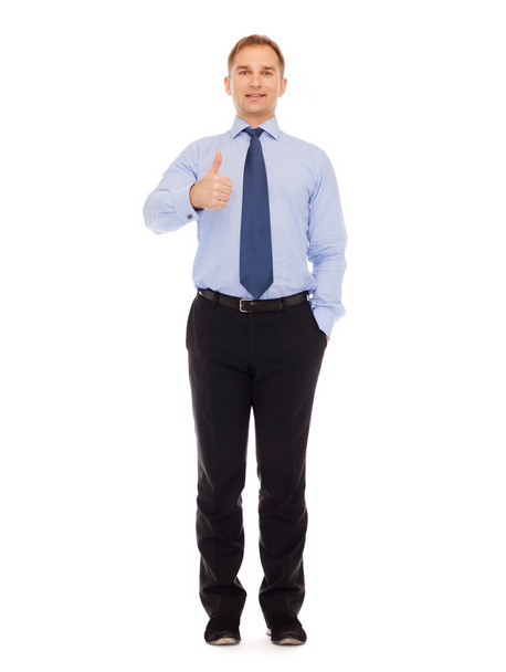 smiling businessman showing thumbs up - Foto, afbeelding