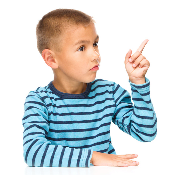 Boy is pointing to the right with index finger - Photo, Image