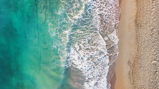 Aerial from drone of an stunning beautiful sea landscape beach with turquoise water at sunrise. Free copy space. - Photo, Image