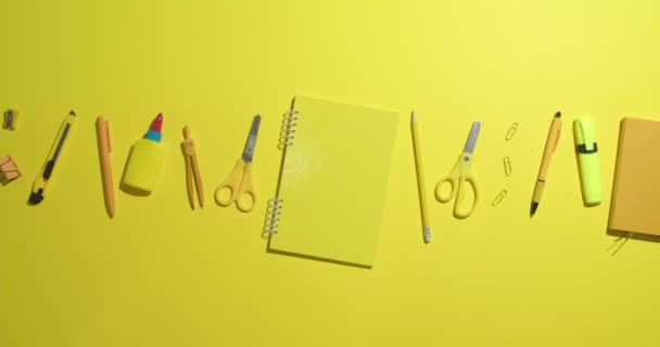 Many school supplies on color background, video with stop motion effect - Footage, Video