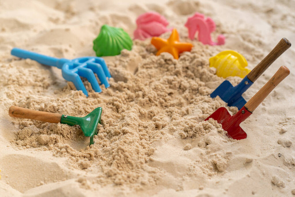 A closeup shot of beach toys on the sand - Фото, изображение