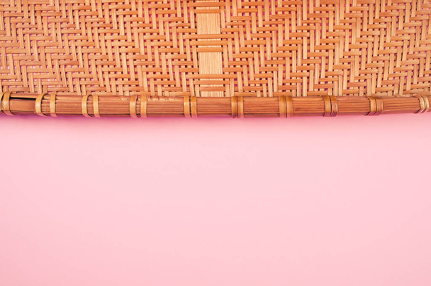 A high angle shot of a woven fabric on a pink surface - Fotoğraf, Görsel