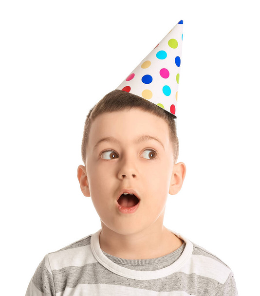 Shocked little boy in party hat on white background - Photo, Image
