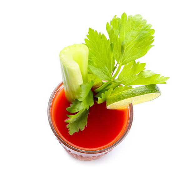 Glass of bloody mary cocktail garnished with cilantro and lime on white background - Foto, Imagen